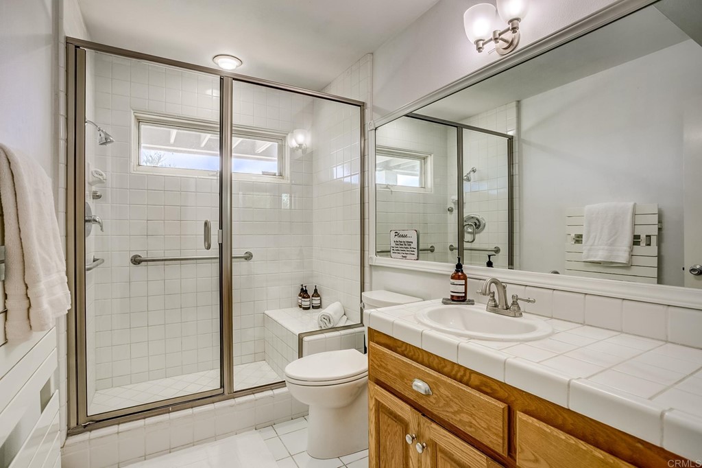 24596 Fuerte Road Temecula, CA 92590 - Photo 24 of 44 a bathroom with a shower sink vanity mirror and toilet