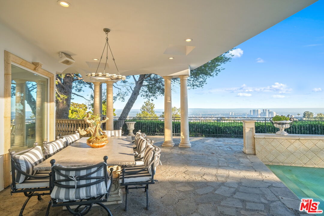 a dining room with furniture and a floor to ceiling window