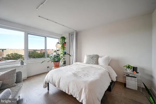 a bed sitting in a bedroom next to a large window