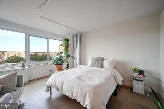 a bed sitting in a bedroom next to a large window