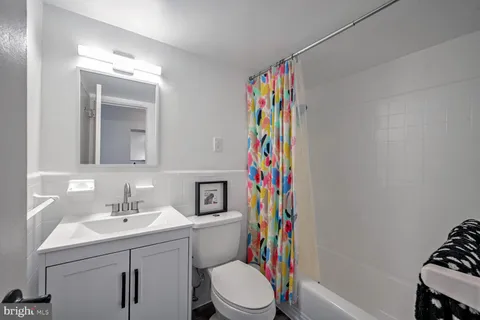 a bathroom with a sink toilet and a mirror