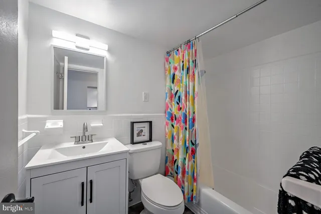 a bathroom with a sink toilet and a mirror