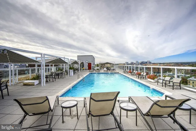 a view of a swimming pool with outdoor seating
