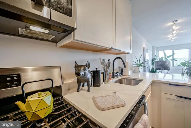 a kitchen with sink and a stove