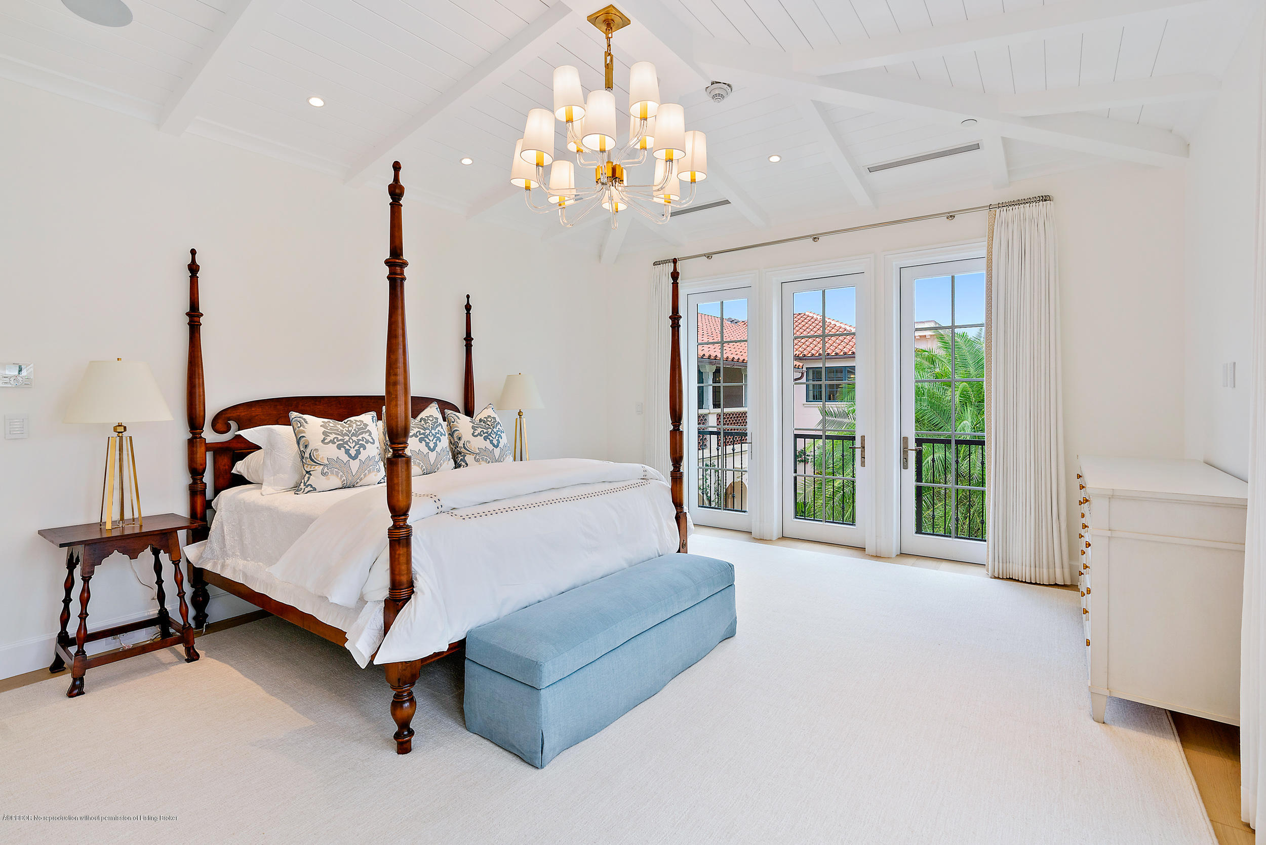 3 Via Flagler Palm Beach, FL 33480 - Photo 21 of 42 a spacious bedroom with a bed a chandelier and large window