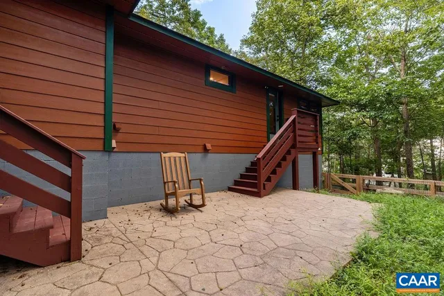a view of a house with a swimming pool and a forest