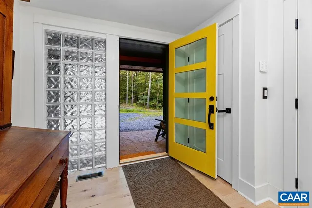 a view of entryway with a door and wooden walls