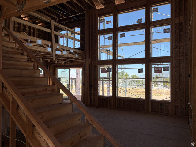 17 South Carson Way Salem, UT 84653 - Photo 3 of 14 Two-story window wall, expansive windows, open-tread staircase, and exposed wood framing