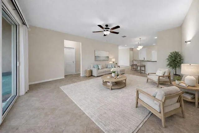 a living room with furniture and a chandelier