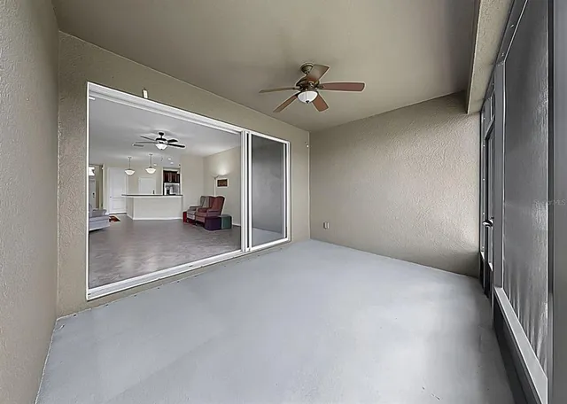 an empty room with a mirror and a fan