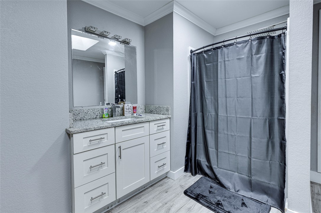 110 Avondale Road Anderson, SC 29624 - Photo 11 of 26 A well-appointed bathroom offers a vanity with granite countertops and modern cabinetry, complementing the shower area.