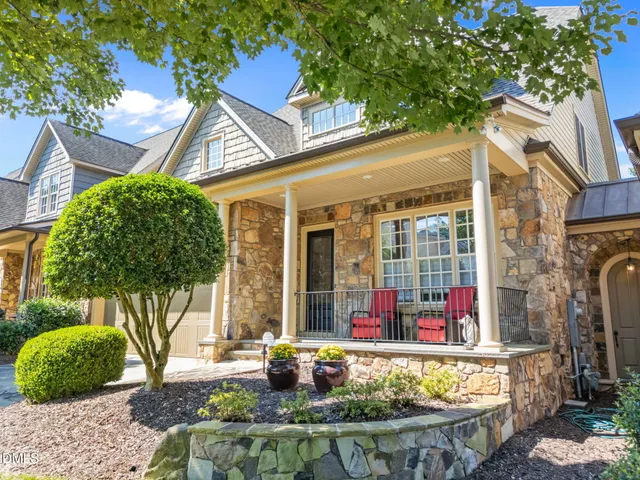 a front view of a house with fountain