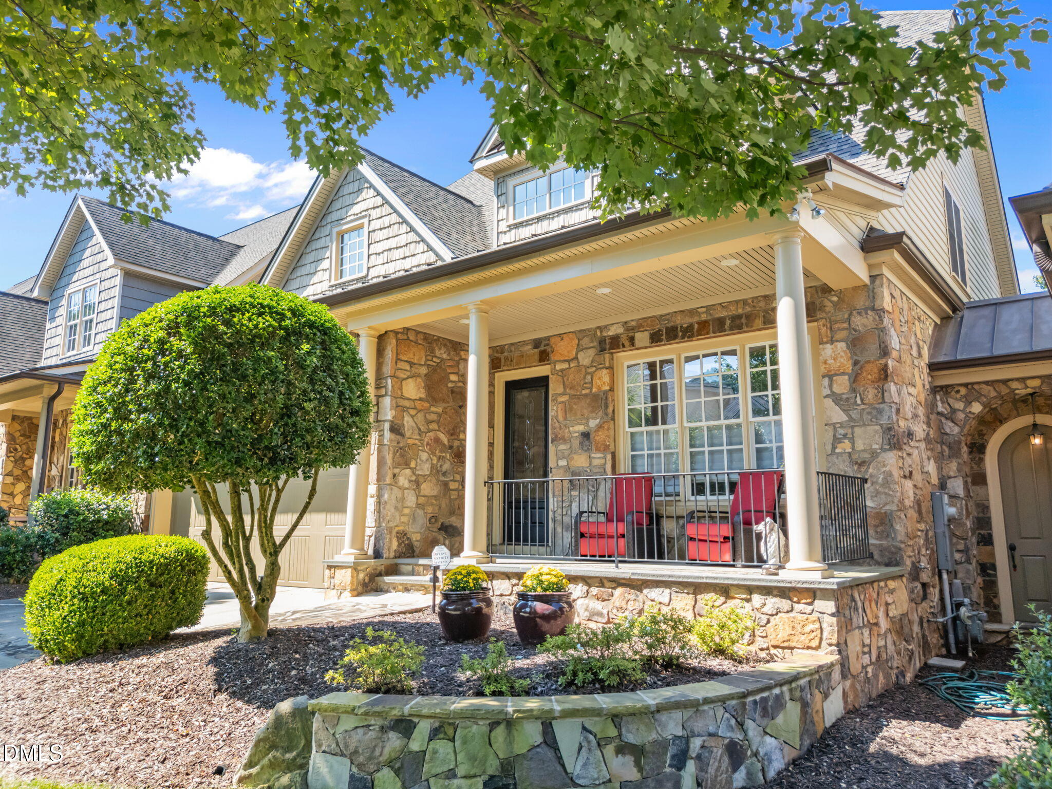 a front view of a house with fountain