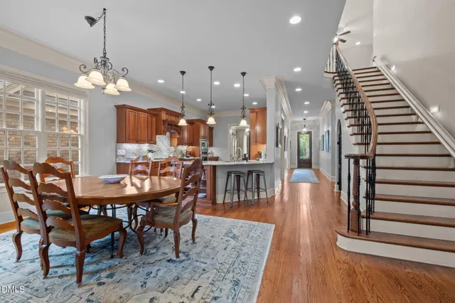 a dining room with furniture entryway and wooden floor