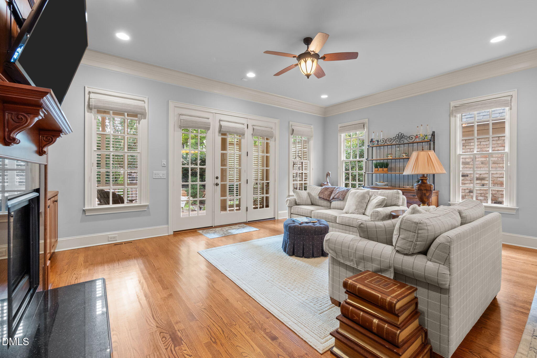 4171 English Garden Way Raleigh, NC 27612 - Photo 15 of 39 a living room with furniture a fireplace and a floor to ceiling window