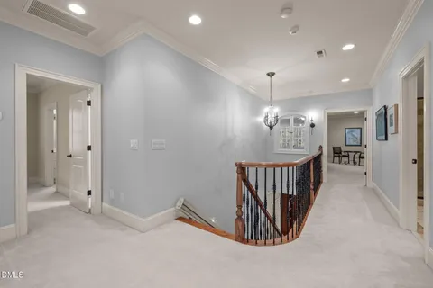 a view of a hallway with chandelier