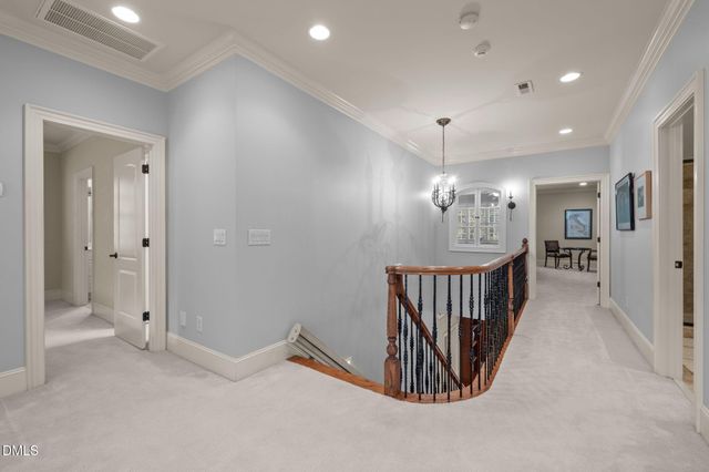 a view of a hallway with chandelier