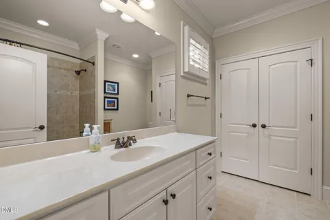 a bathroom with a sink vanity granite and a mirror