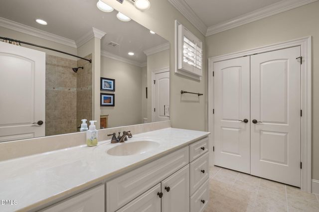 a bathroom with a sink vanity granite and a mirror