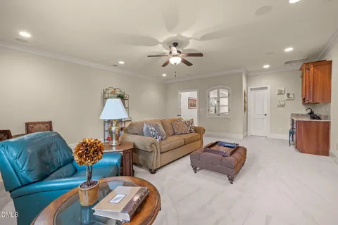 a living room with furniture ceiling fan and a lamp