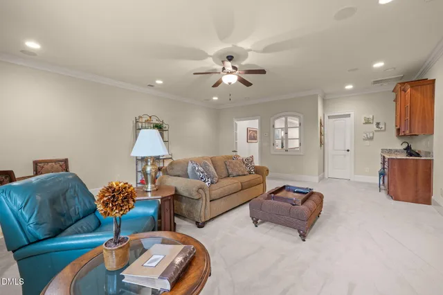 a living room with furniture ceiling fan and a lamp
