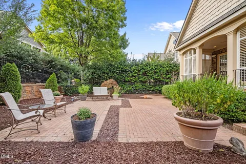 a view of a backyard with garden and patio