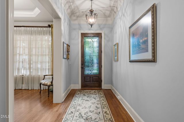 a view of hallway with wooden floor and a front door