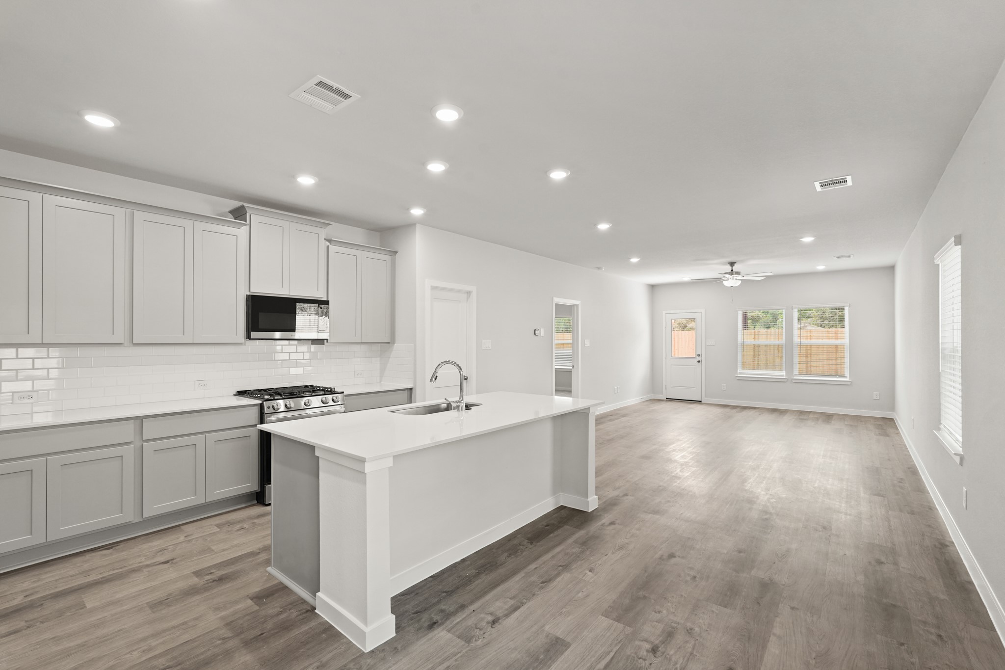213 Spring Drive Hockley, TX 77447 - Photo 5 of 26 a kitchen with a sink stove and cabinets