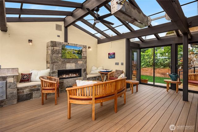 a living room with furniture a fireplace and wooden floor