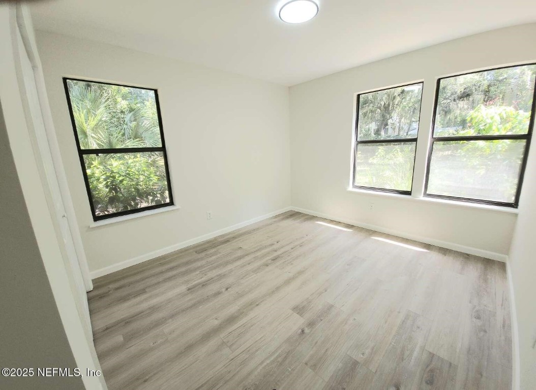 1347 Autumn Trace Fernandina Beach, FL 32034 - Photo 14 of 20 a view of an empty room with wooden floor and a window