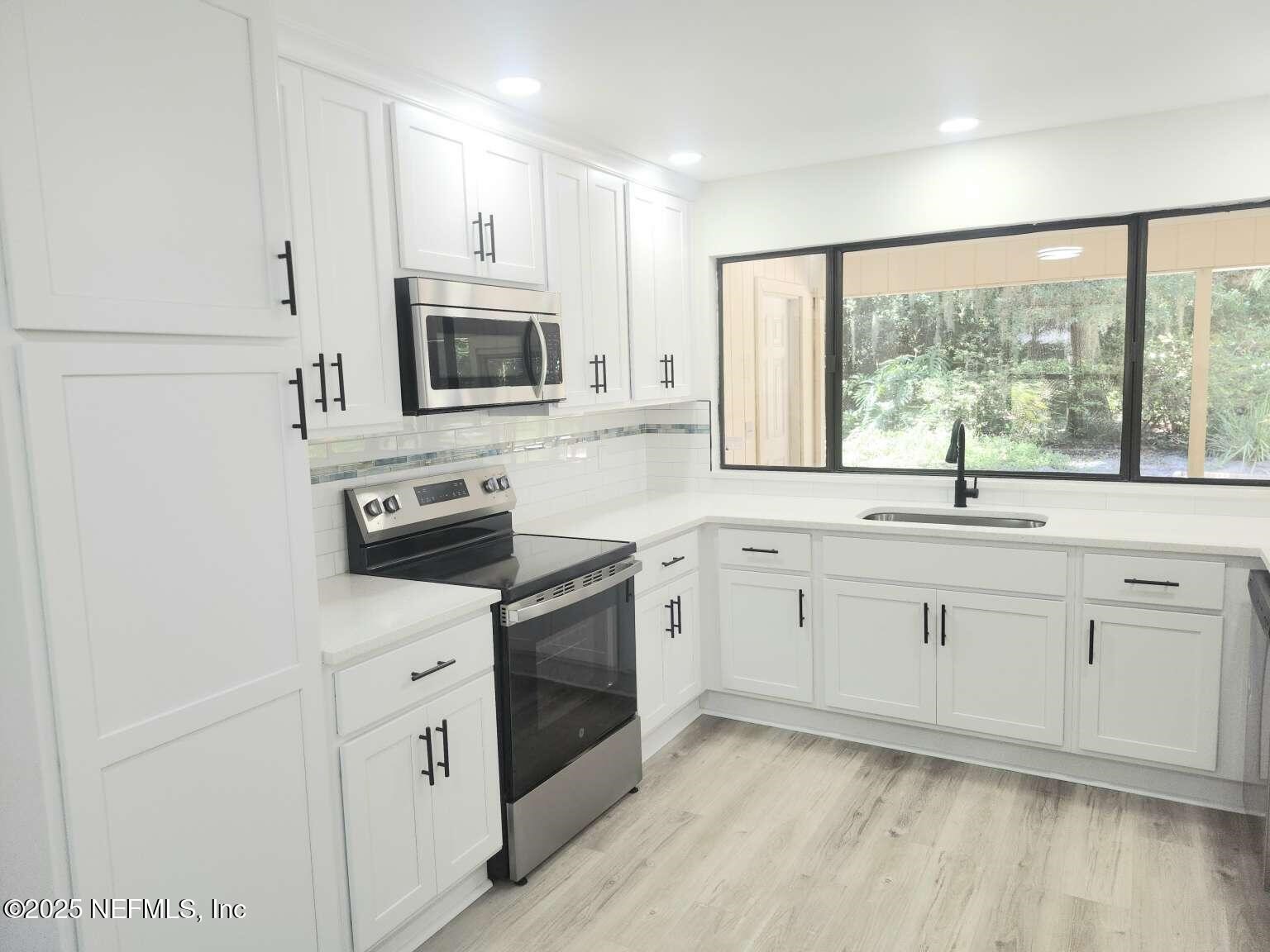 1347 Autumn Trace Fernandina Beach, FL 32034 - Photo 4 of 20 a kitchen with appliances cabinets and a sink
