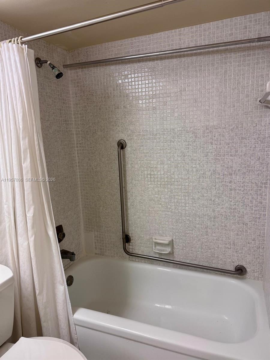 272 Dorset East, Unit G Boca Raton, FL 33434 - Photo 7 of 10 a bathroom with a shower and a toilet