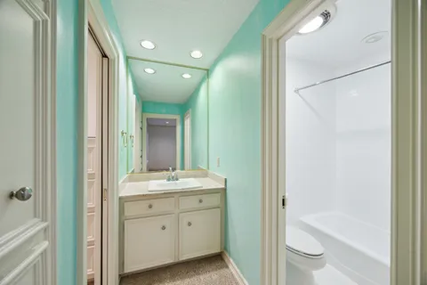 a bathroom with a shower a sink and a mirror