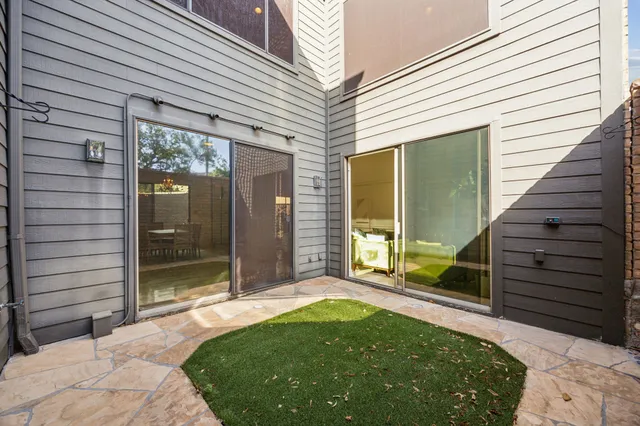 a living room with furniture a fireplace and a chandelier