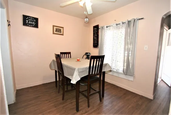a view of a dining room with furniture and wooden floor