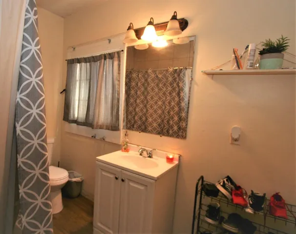 a bathroom with a sink toilet and shower