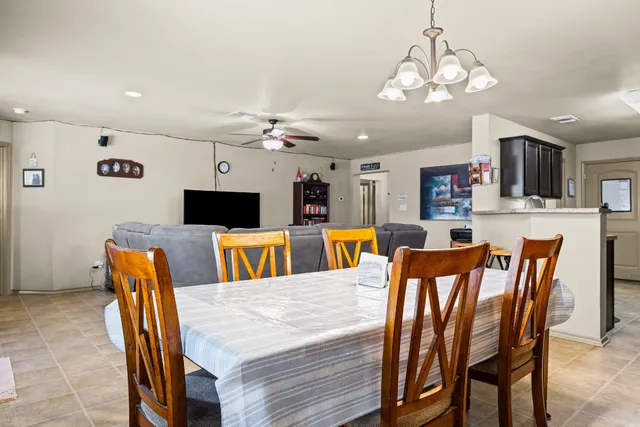 a view of a dining room with furniture and a chandelier