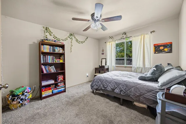 a bedroom with bed and a book shelf
