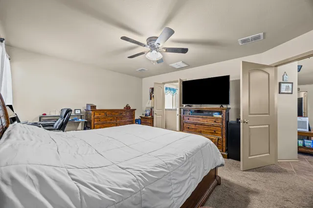 a bed room with a bed and a flat screen tv