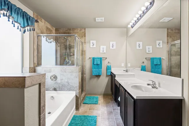 a bathroom with a tub sink and mirror