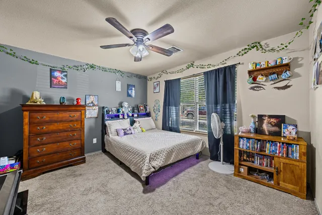 a bedroom with a bed and a bookshelf