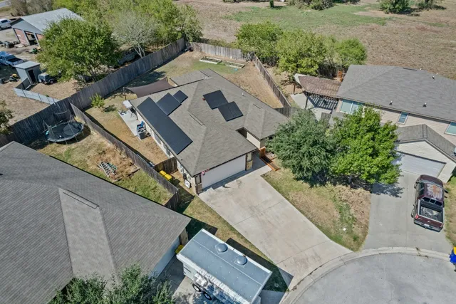 an aerial view of a house with a yard