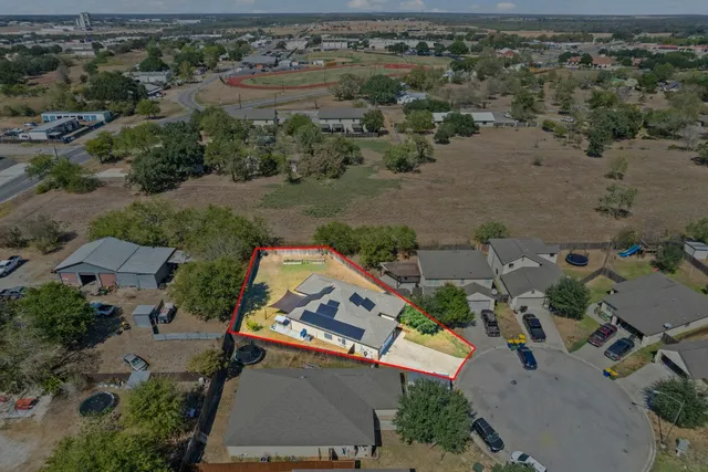 an aerial view of a house with a lake view