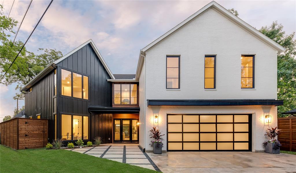 a front view of a house with a yard and a garage