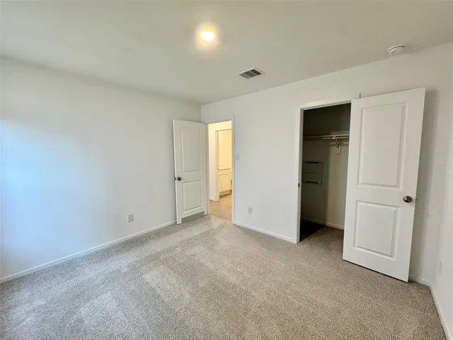 an empty room with closet area