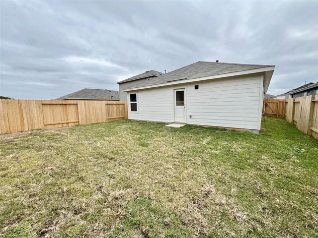 a view of a house with a yard and garage