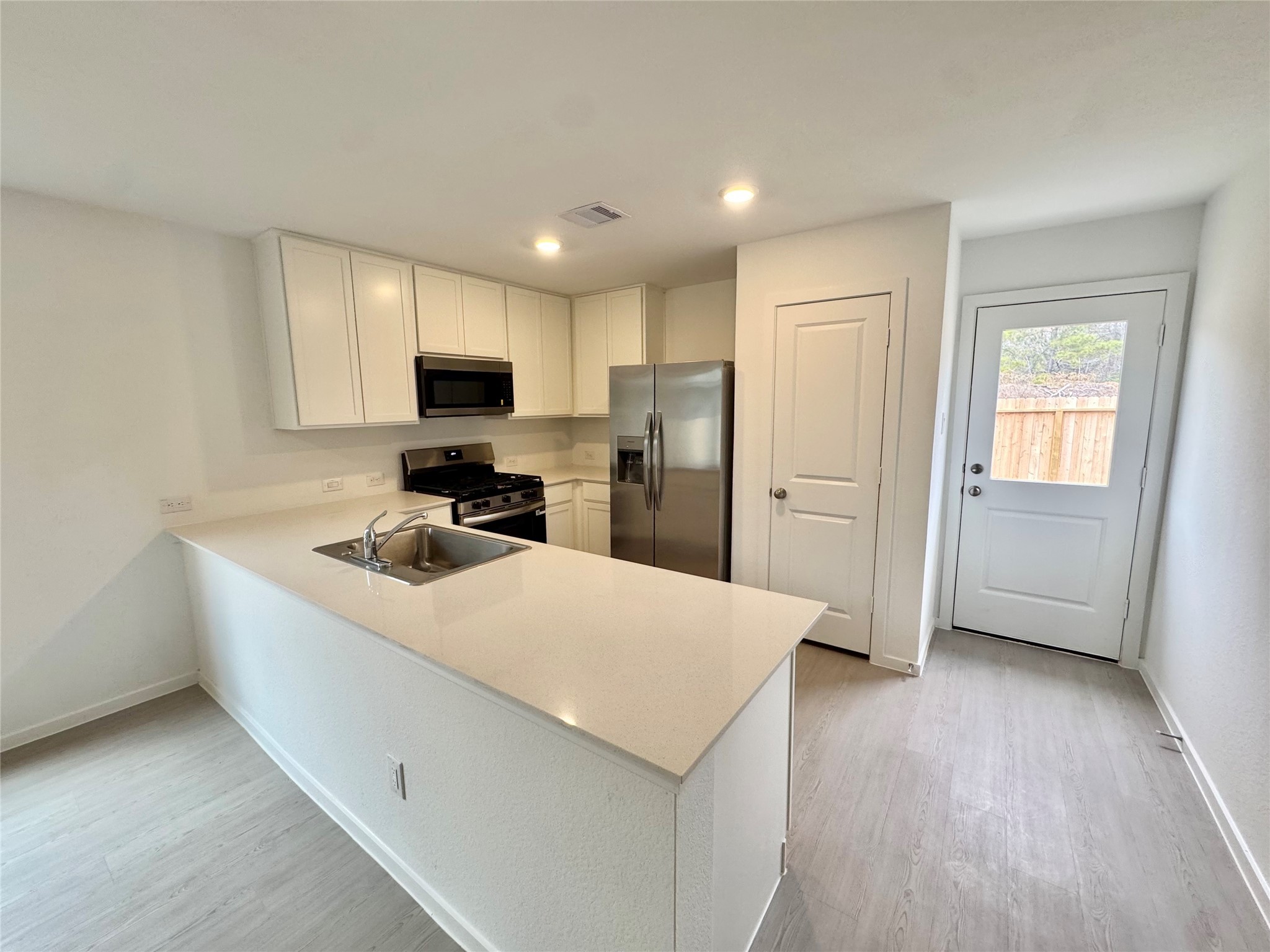 14885 North Ascot Bnd Circle Conroe, TX 77306 - Photo 5 of 14 a kitchen with stainless steel appliances a refrigerator sink and microwave