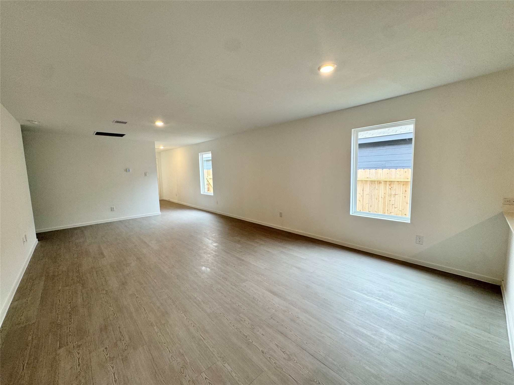 14885 North Ascot Bnd Circle Conroe, TX 77306 - Photo 6 of 14 a view of an empty room with wooden floor and a window