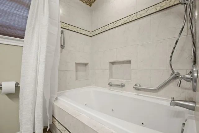 a bathroom with a tub and shower