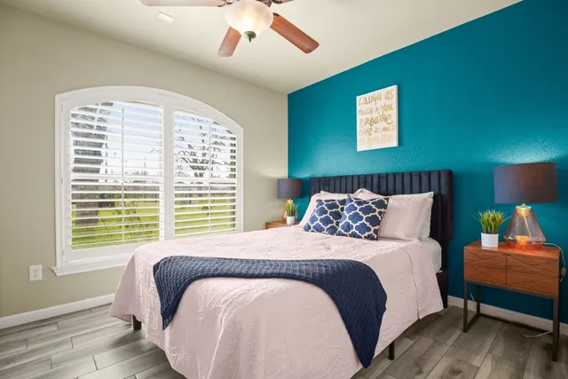 a bedroom with a bed and wooden floor